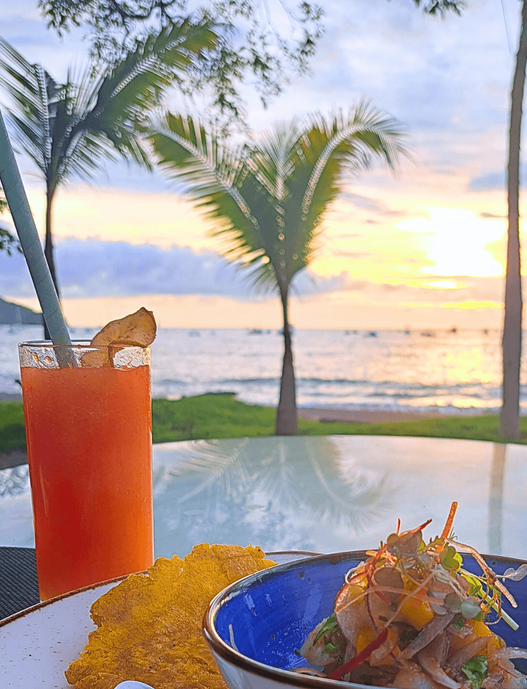 Decorative cover image for mobile webpage. Features a beach at sunset, with an orange drink in the foreground
